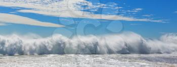 Blue wave on the beach. Blur background and sunlight spots. Dramatic natural background.