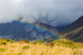 Rainbow above mountains. Beautiful natural landscapes. Picturesque nature.