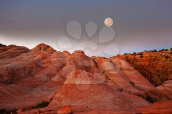 The landscapes of Utah's rocky desert under a full moon