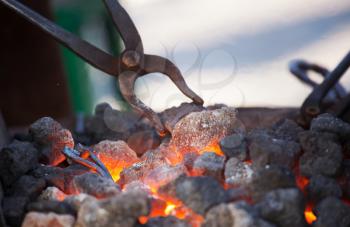 Old fashioned blacksmith furnace with burning coals