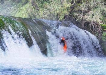 Kayaker in waterfall