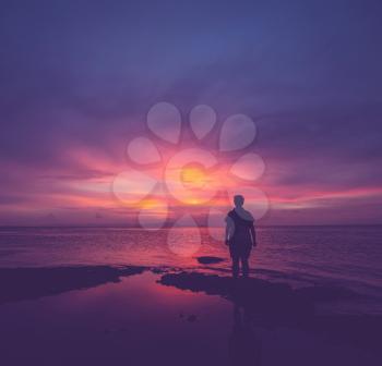 Girl silhouette on the sunset background