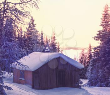 wooden hut in the mountains at winter