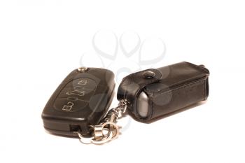 Car keys and charm on a white background