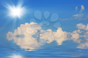 Shining sun in the blue sky and water