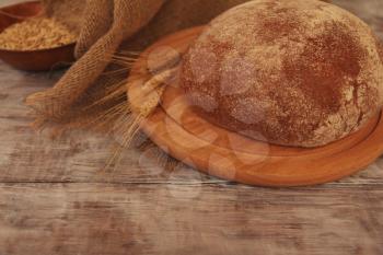 Homemade baked bread on wooden table. Food background