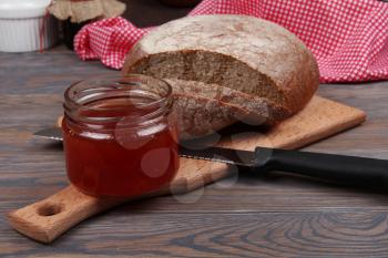 Rye bread and jam on wooden background