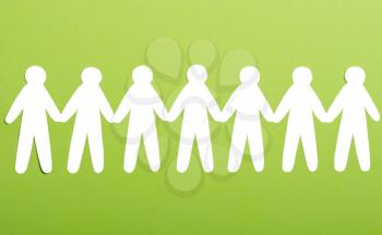 team of paper people on green background