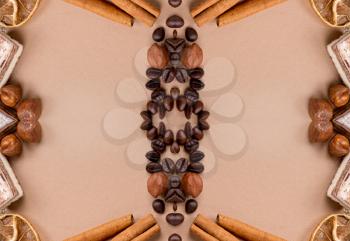 Close up of coffee, cinnamon, nuts, sweet on old paper material. Place for text.