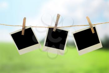 Three blank instant photos hanging on the clothesline