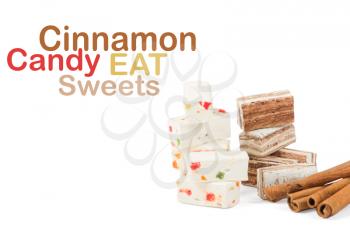 Sweets and cinnamon sticks isolated on white background