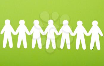 team of paper people on green background