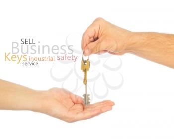 Male hand holding a car key and handing it over to another person isolated
