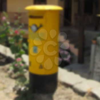 Blurred yellow letter box. Cyprus.