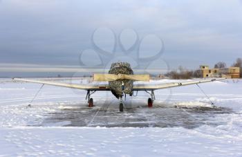 Propeller plane parking at the airport in winter