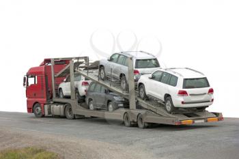 Transporter with cars in the back, on white background.