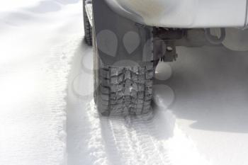 Car tires on the winter road