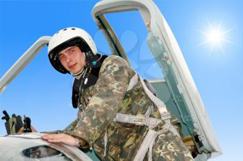 The military pilot in the plane in a helmet                               