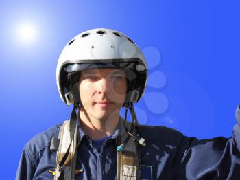 The military pilot in a helmet in dark blue overalls separately 