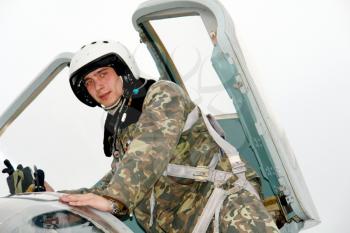 The military pilot in the plane in a helmet                               