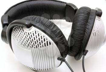 The big silvery headphones with the black holder on a white background