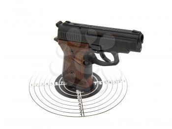 The pistol with the brown handle with a target and cartridges lies on a white background