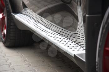 Footboard of the car of silvery color with a structure
