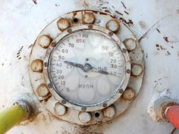 Industrial pressure meter - barometer and water pipes in the background