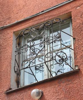metal forged carved lattice at a plastic white window