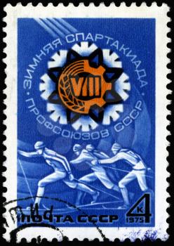 USSR - CIRCA 1975: A post stamp printed in the USSR shows running skier, devoted to the Winter Games of Soviet Trade Unions, series, circa 1975