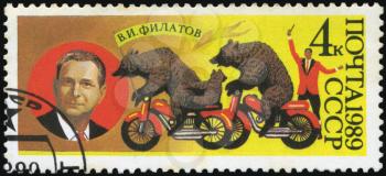 USSR - CIRCA 1989: stamp printed in USSR, dedicated to the circus, shows Soviet bear trainer Valentin Filatov and bear on a motorcycle, circa 1989
