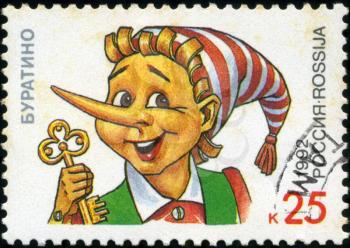 RUSSIA - CIRCA 1992: A stamp printed in Russia shows Pinocchio holding a golden key, series Characters from Children's Books, circa 1992
