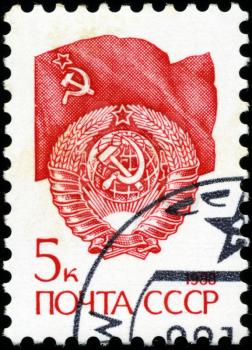 USSR - CIRCA 1988: A stamp printed in USSR shows State Emblem and flag of the Soviet Union , series Emblem , circa 1988