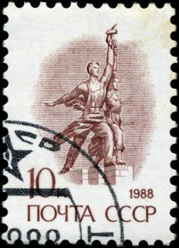 USSR - CIRCA 1988: A stamp printed in USSR shows sculpture Worker and Kolkhoz Woman, series Emblem , circa 1988