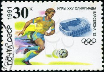 USSR - CIRCA 1991: A stamp printed in USSR, football, soccer, Olympic Games in Barcelona 1992, player hits the ball, circa 1991