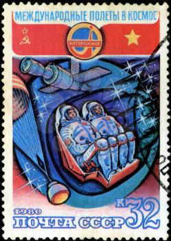 USSR - CIRCA 1980: a stamp printed by USSR, International space travel, astronauts in spaceship, parachute, station Mir, circa 1980