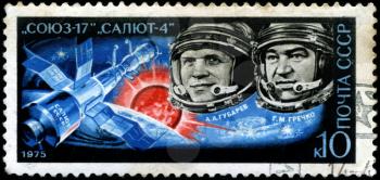 USSR - CIRCA 1975: A post stamp printed in USSR (Russia), shows famous astronauts Gubarev and Grechko, with inscriptions and name of series Soyuz - 17 and Salyut - 4 spacecraft, circa 1975