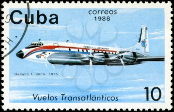 CUBA - CIRCA 1988: A Stamp printed in CUBA shows image of the airplane in transatlantic flight, Habana - Luanda in 1975, circa 1988