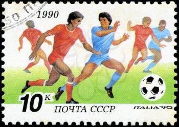 USSR - CIRCA 1990: a stamp printed by USSR shows football players. World football cup in Italy, series, circa 1990
