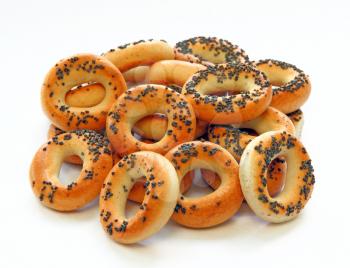 Drying bagels with poppy seeds on a white background