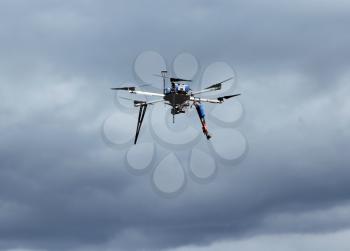 Flying  drone in the sky with mounted  digital camera.