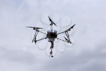 Flying  drone in the sky with mounted  digital camera.