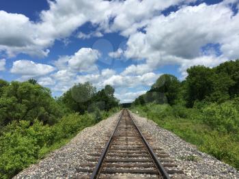Railway to horizon and clouds on the sky background.
