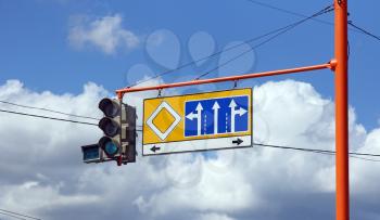 Green traffic signs with the direction of travel on a background of blue sky.