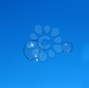 Soap bubble flying against the blue sky.