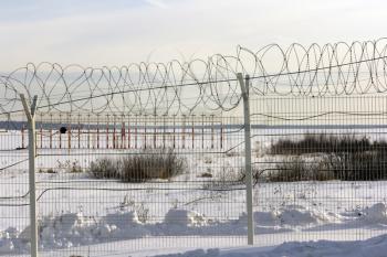 Antennas airport for a barbed wire fence in winter.