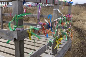 Bridge desires railing tied with colored ribbons.