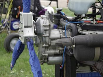 Aircraft piston engine with a three-blade blue propeller.