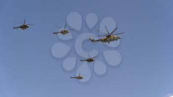 MOSCOW - MAY 7: combat helicopters Mi-26 and Mi-8 fly in sky on training parade in honor of Great Patriotic War victory on May 7, 2017 in Moscow, Russia.