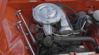 Internal combustion engine of a red car close-up.